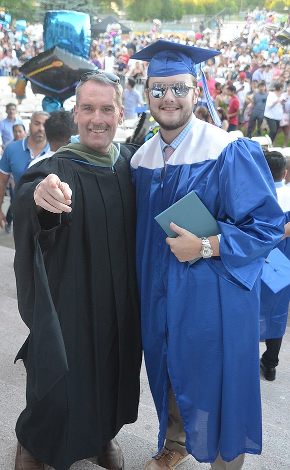 Proud father and Deputy Superintendent Joseph Durney poses for a photo with his newly graduated son, Myles.