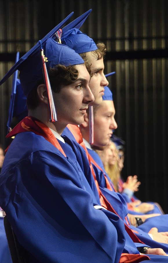 On the edge of a row of Class of 2019 graduates, Philip Kovacevic pensively listens to speakers during the ceremony.