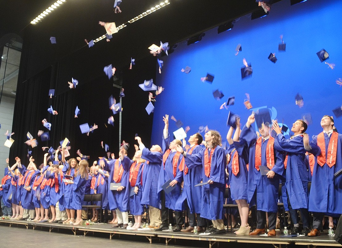 Once their graduation is officially recognized, the Class of 2019 simultaneously throw their caps into the air in celebration.