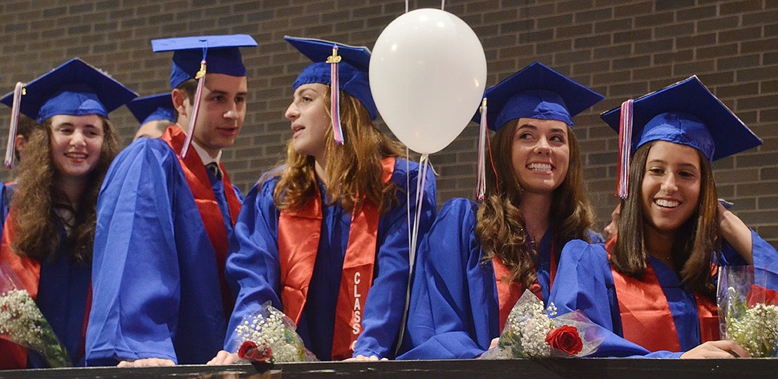 Chatting and smiling amongst themselves, Harris Blumenthal (left), Chloe Bittelman, Hannah Bailey and Kayla Axelrod line up on the staircase in the lobby before entering the auditorium.