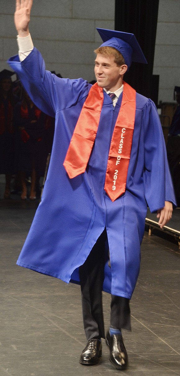 As the first student called, Michael Abrutyn waves to the cheering audience as he makes the memorable walk across the stage to receive his diploma.