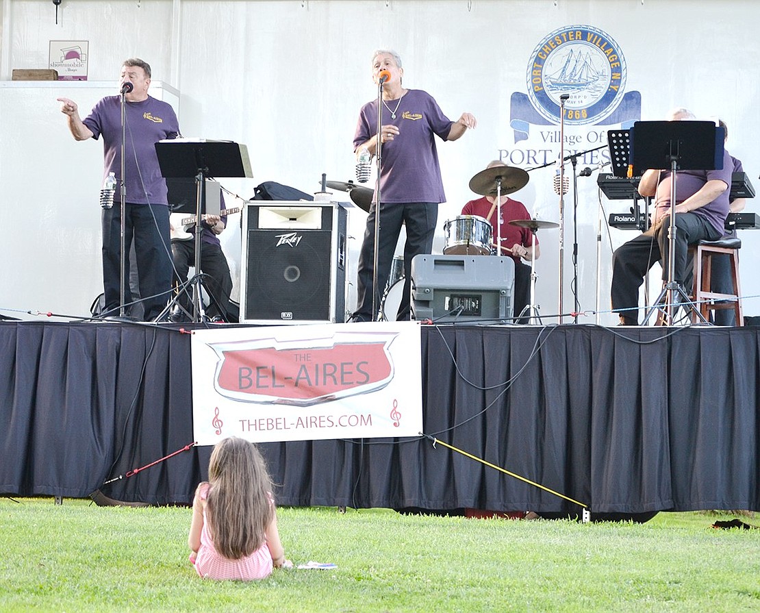 Jillian Larmon, 7, sits front and center before the Showmobile to watch the Bel-Aires, a Westchester-based band who perform hits from the 50s and 60s, at Lyon Park on Friday, July 12. The White Plains resident is visiting family to attend the kick-off Concerts in the Park show, a series sponsored by Port Chester Recreation that features live music and food trucks every Friday night from 7:30 p.m. to 9 p.m.