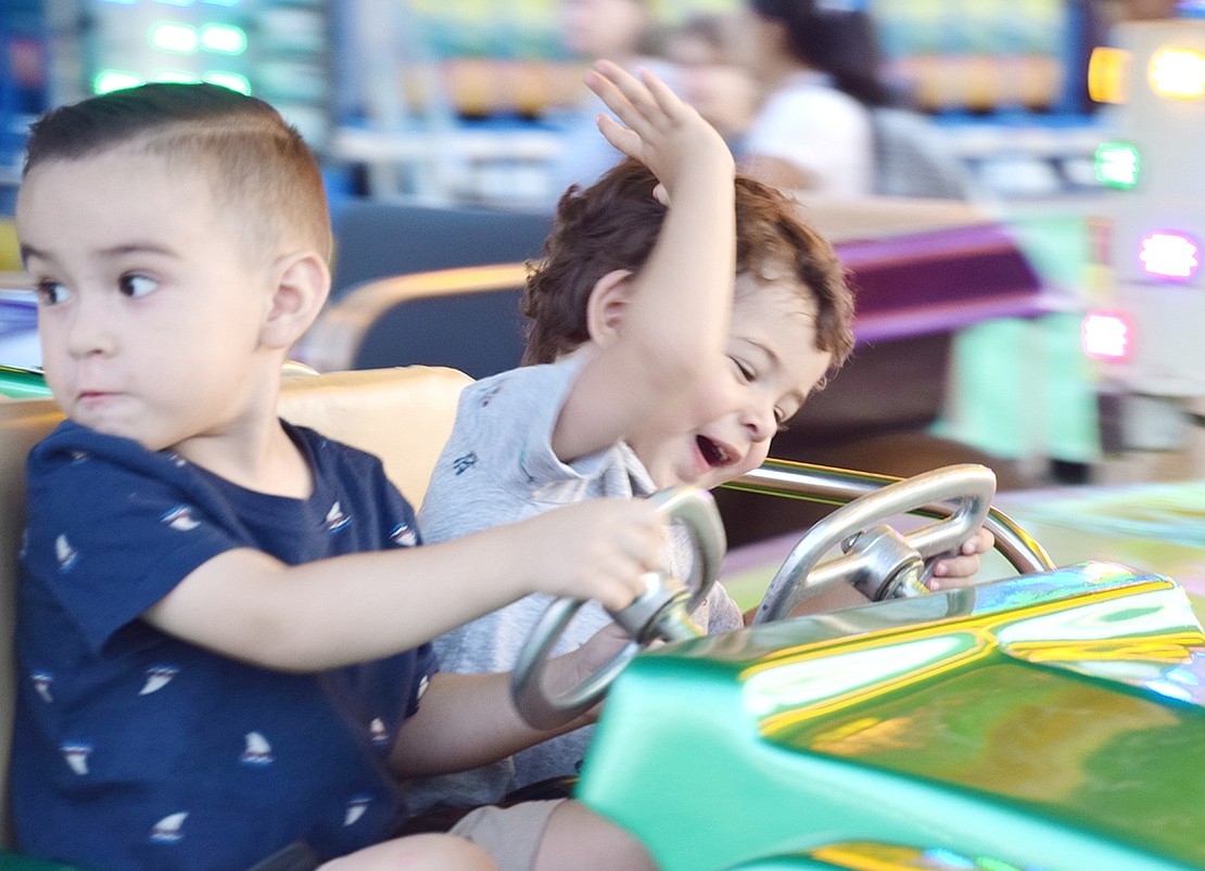 Watch out! Port Chester residents Franky Hernandez, 3, and his 2-year-old friend Jayden Burkhead (right) may be having a little too much fun behind the wheel on the toddlers’ car ride on the first night of the St. John Bosco Carnival on Monday, Aug. 12. The fun will continue every night through Saturday at the Corpus Christi Field on South Regent Street starting at 6 p.m.