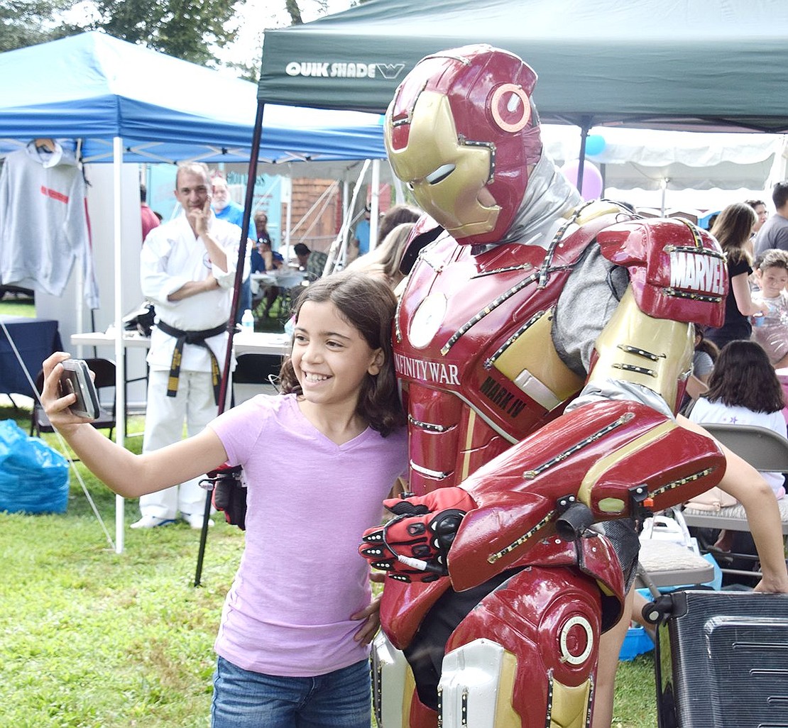 As soon as Iron Man gets his gear on, Pietra Moradi quickly steps up for a superhero selfie. The 9-year-old Irvington resident is checking out the festivities while her father David promotes his Port Chester-based business, Westchester Tae Kwon Do.