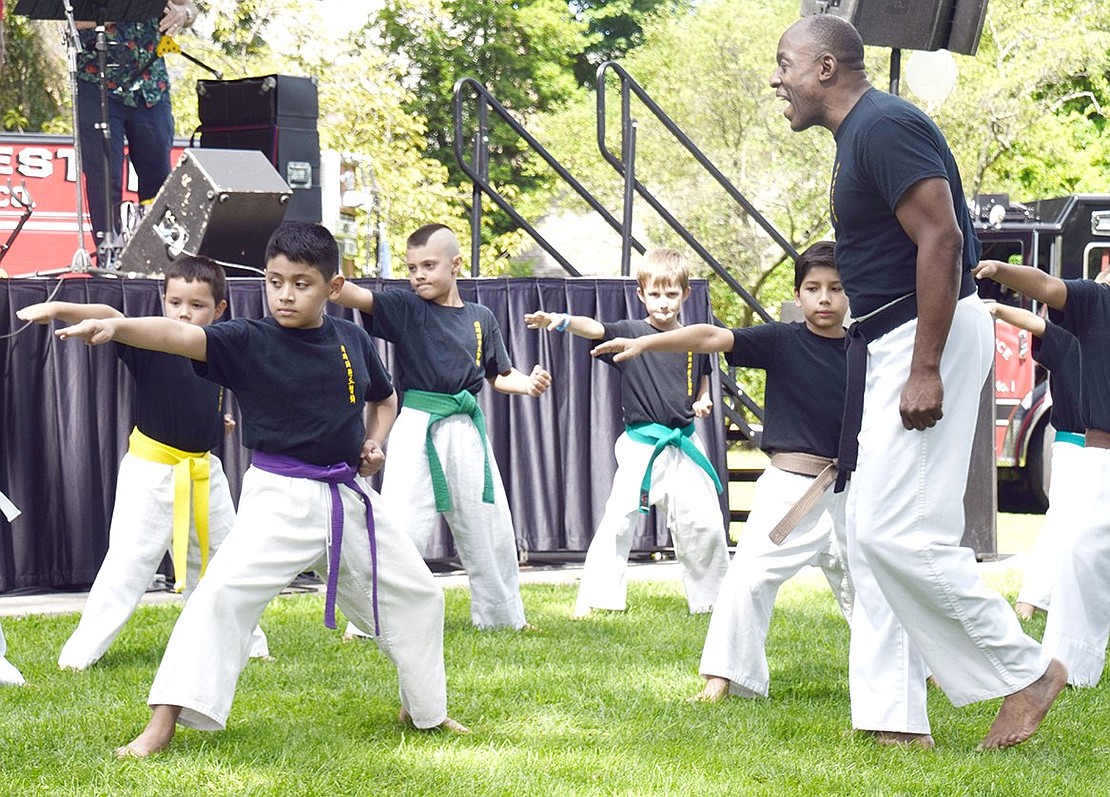 Students in the Westchester World Tae Kwon Do Association diligently follow orders as instructor Russell Fulmore, of White Plains, gives commands during a martial arts demonstration.