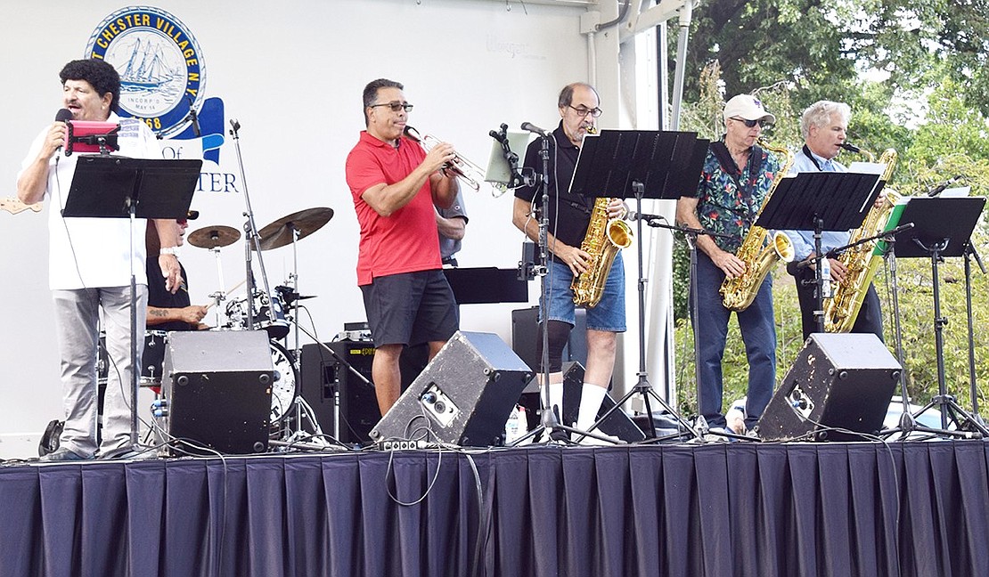 The band Mighty Tight plays a brass-infused rendition of “My Girl” by the Temptations on the Showmobile.