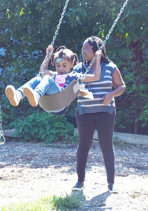 To get the sugar rush out, Nariah Jones flies high on the John F. Kennedy swing set, with helpful pushes from her mother Yolanda Thomas, a Weber Drive resident.