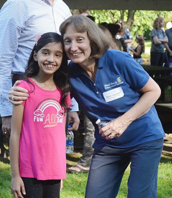 Now a first-grade teacher at Ridge Street School, Karen Tagliaferri hugs her former student Rianna Battiwalla, 8, from her second-grade class last year.