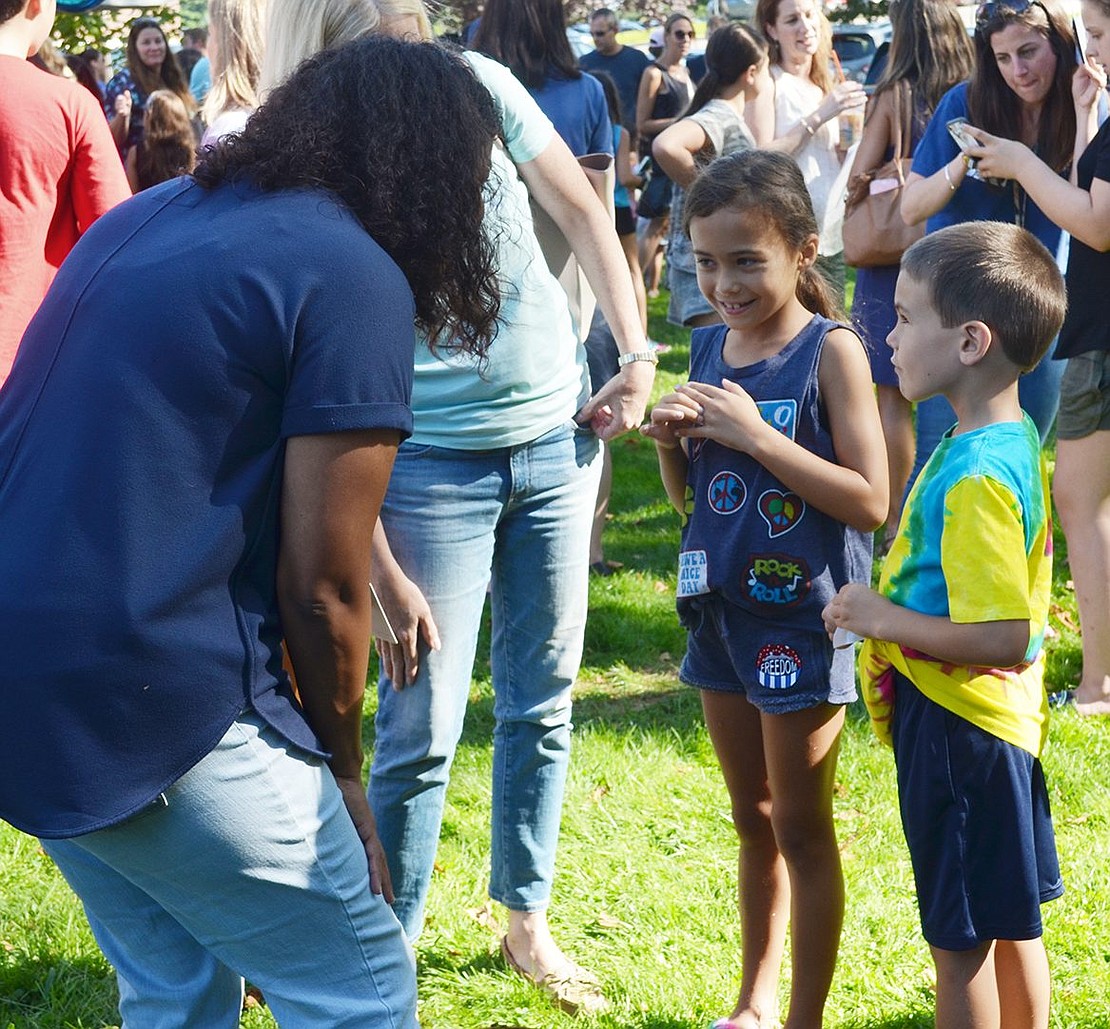 Third-grade teacher at Ridge Street School Kerri James smiles as she leans down to introduce herself to her new student, 7-year-old Mackenzie Pigassou.