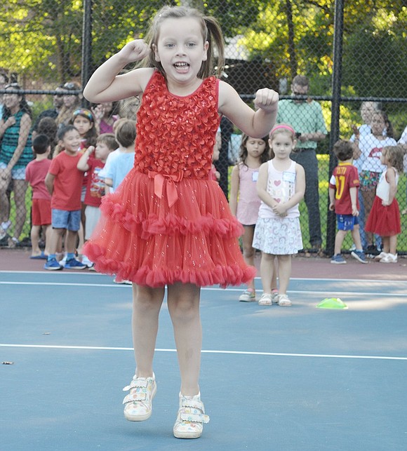 Diane Pring’s red dress sparkles as she jumps high during the annual Kindergarten Social on Tuesday, Sept. 3. The 5-year-old is competing in one of the various games put on through Hi-Five Sports Club at the Harkness Park tennis courts.