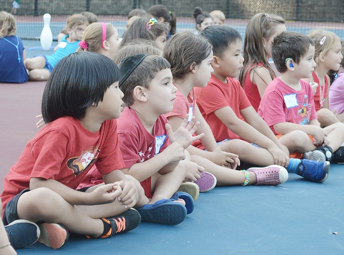 The red shirt team, which was comprised of students in Geri Fisher’s kindergarten class, gets ready to face off against the white shirts, the future students in Lisa Mecca’s class, in a game of Red Rover.