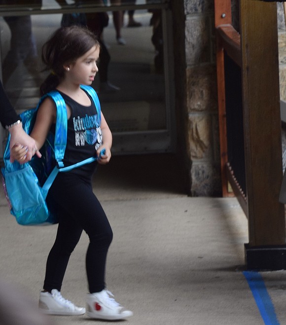 With a bright blue backpack as big as her body, kindergartner Samantha Wiener energetically enters the crowd of parents and guardians outside of Ridge Street Elementary School. 