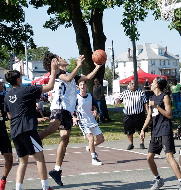 Soon to be Purdy Avenue resident Alvin Vargas, 16, gets ready to jump above his opponents and score during a Unity Day scrimmage basketball game. Vargas was one of many who came out to Columbus Park on Saturday, Sept. 28, to celebrate Unity Day, a tradition that brings together past and current residents of Port Chester’s public housing units.