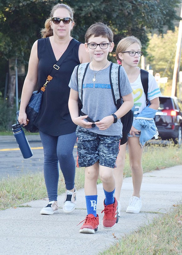 Second-grader Lucas Weinfeld, 7, walks to Ridge Street School wearing his best Blind Brook attire.