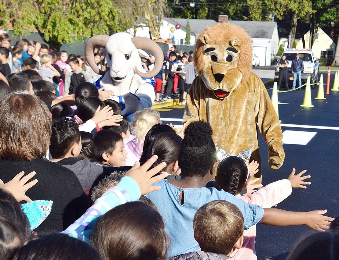After their grand entrance in a Port Chester police car, the Port Chester High School mascot Rammy (played by high school junior Gianna Villanova) and King Street School mascot Roary (played by Port Chester Middle School seventh-grader John Pauletti) jump out and greet the eager crowd of students.