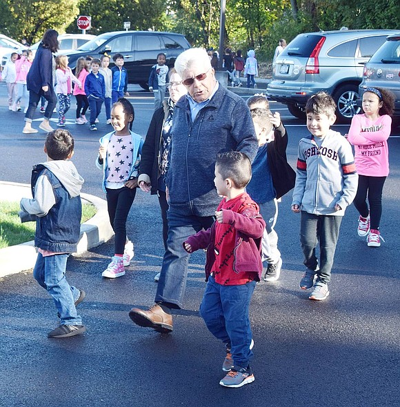 Port Chester Mayor Richard “Fritz” Falanka chats with a few King Street School students as they walk around the parking lot after the Walk to School Day ceremony.