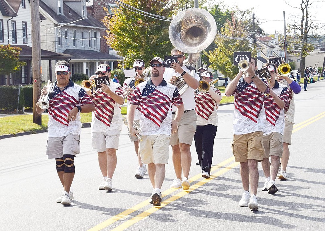 The Tappan Zee Bridgemen band do a little dance as they strut down Westchester Avenue.