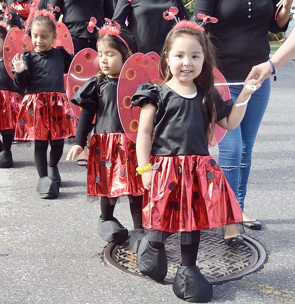 Literally cute as a bug, 3-year-old Shanne Urrutia is the first in line of several other appropriately dressed toddlers from Port Chester’s Ladybug Family Daycare making their way down the road.