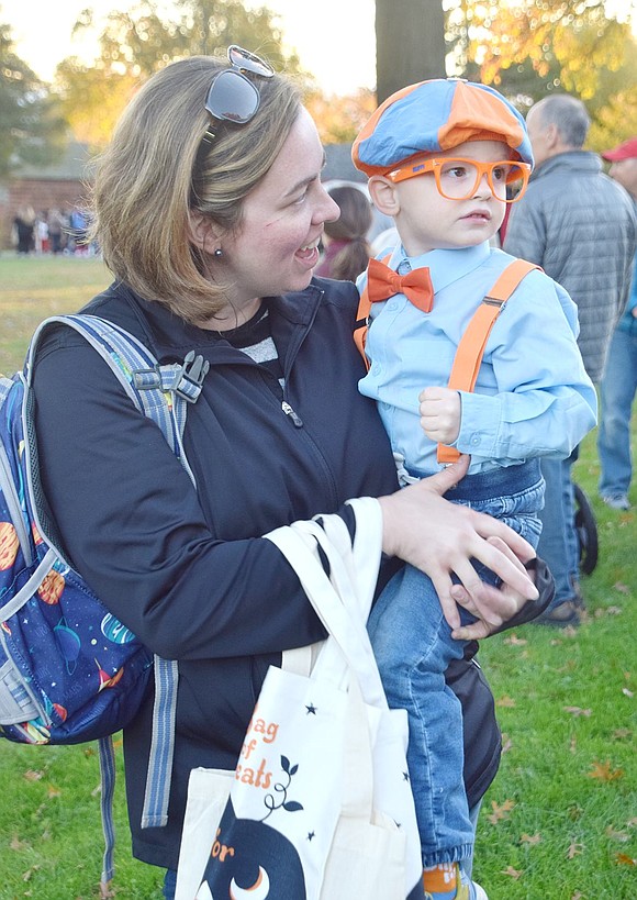 Greenwich, Conn. resident Charron Carucci adoringly looks at her son Benjamin, dressed as YouTube educational video star Blippi. Paying no attention to his mother, the 3-year-old is intrigued by the monsters and superheroes walking across the stage.