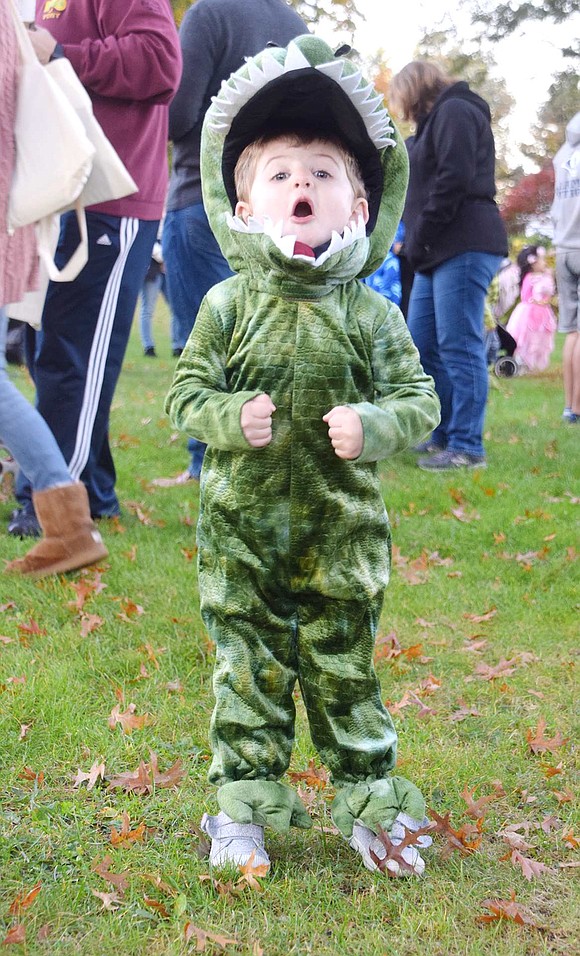 John Herrick takes a deep breath and practices his scary, thundering roar. Appropriately, the 2-year-old Upland Street resident is dressed up as Tyrannosaurus Rex.