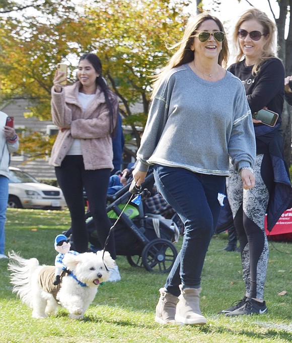 Bonwit Road resident Annette Morlino directs her dog Murphy, dressed as a jockey, around the course.