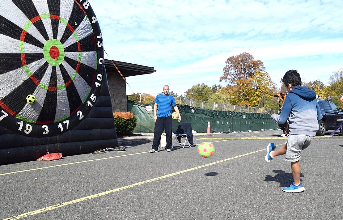 After successfully kicking and sticking a felt soccer ball on the giant target, Blind Brook Middle School sixth-grader Ziad Attia, 11, sends another one flying in the Ridge Street School parking lot.