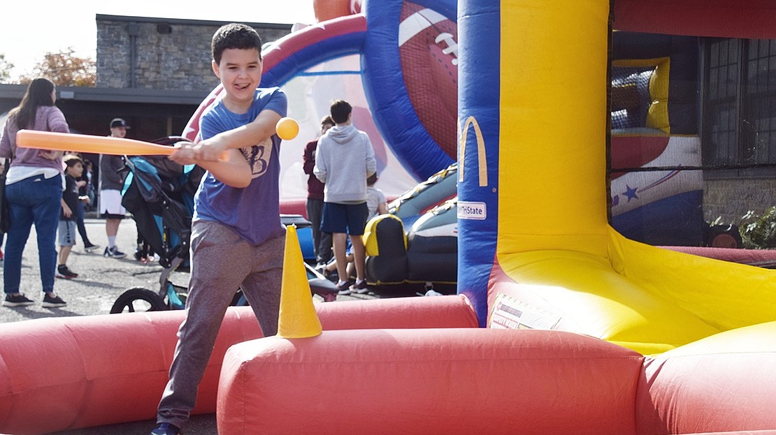 Batter up! Ridge Street School fourth-grader Andy Montvelisky, 10, gets ready to swing at the air propelled ball.