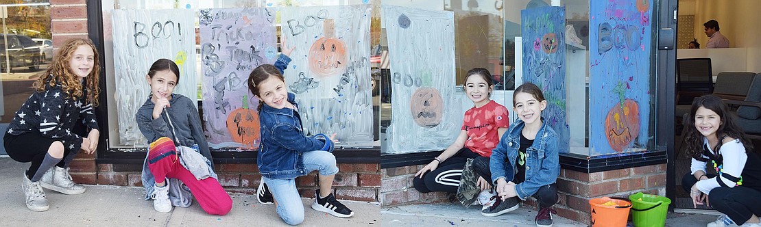 A group of 8-year-olds pose in front of their spooky window paintings. From the left: Red Roof Drive resident Mia Vickers, West Ridge Drive resident Aerin Tauber, Paddock Road resident Hayden Candee, Horseshoe Lane resident Hayden Sassower, Latonia Road resident Brooke Vinikoor, and Dorchester Drive resident Hannah Levitan.