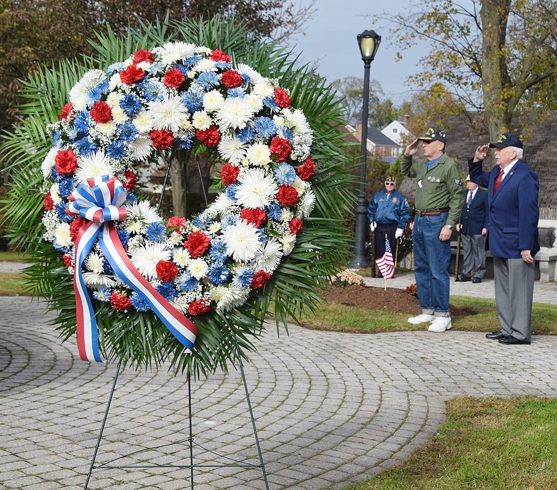 With a memorial wreath in the foreground, veterans Marvin Goldowsky of Port Chester and Vincent Lyons of Rye Brook salute during the Pledge of Allegiance at the Rye Town Veterans Day ceremony at Veterans’ Memorial Park in Port Chester on Sunday, Nov. 10. A handful of politicians, a dozen veterans and a dozen other residents came out to commemorate those who have served, those who have died and those who continue to serve the country in the military.