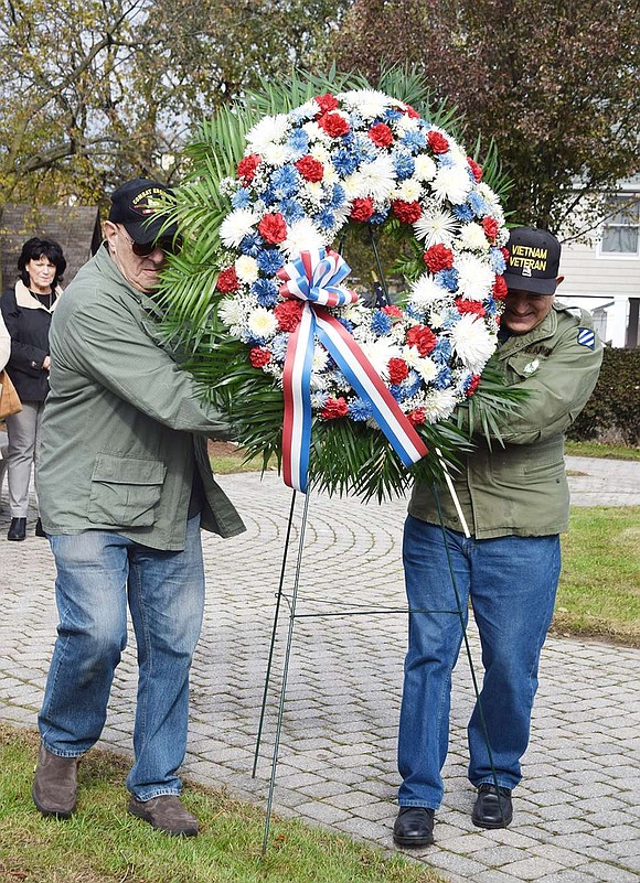 Vietnam veterans and cousins Peter Sileo of Rye Brook and Dominick Mancuso of Port Chester place a memorial wreath in remembrance of those who have died in service to their country in front of the central monument at Veterans’ Memorial Park. The marker commemorates those who served and died in World War I.