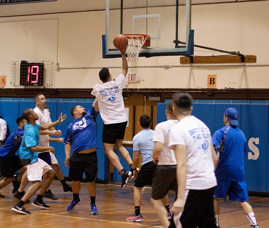 Despite physical education teacher Joseph Facciola’s blocking attempt, Police Officer Andy Polanco jumps up to sink a basket in a fun game last Wednesday, Nov. 6 between the Port Chester School District teachers and staff and the Port Chester Police Department to benefit the Rams and Lady Rams basketball programs. The cops pulled out a 69-50 victory. A total of $1,350 was raised at the event including $500 donated by the Port Chester Police Association.
