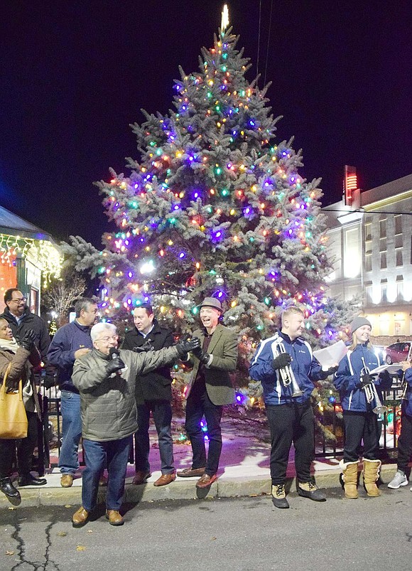 Residents and politicians endure the cold night on Tuesday, Dec. 3 to watch the Village of Port Chester Christmas tree light up Liberty Square with bright colors of blue, red, green and yellow. 