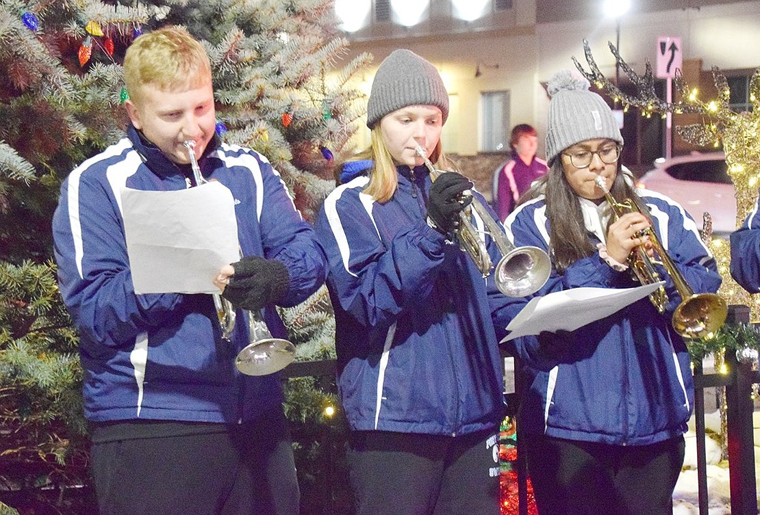 Seniors Joseph DeCarlo, 17, Molly Brakewood, 16, and Karen Rios, 18, set the mood by playing holiday music along with the rest of the Port Chester High School Brass Ensemble.