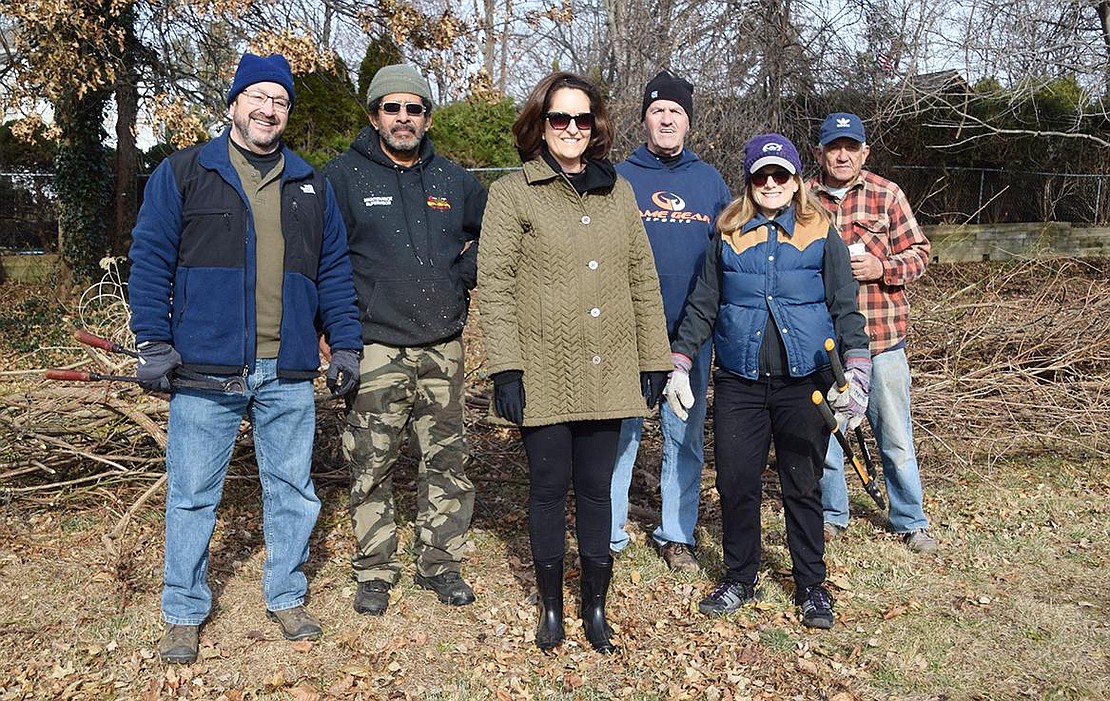 Six of the volunteers and Town of Rye employees who spent the day maintaining pose for a photo in front a pile of vines at Crawford Park. From the left: volunteer Barry Zingman, part-time groundskeeper Sal Valiente, volunteer Maria Bannon, Director of Grounds and Facilities Victor Federico, Confidential Secretary Debbie Reisner, part-time groundskeeper Hippolito Cancel.