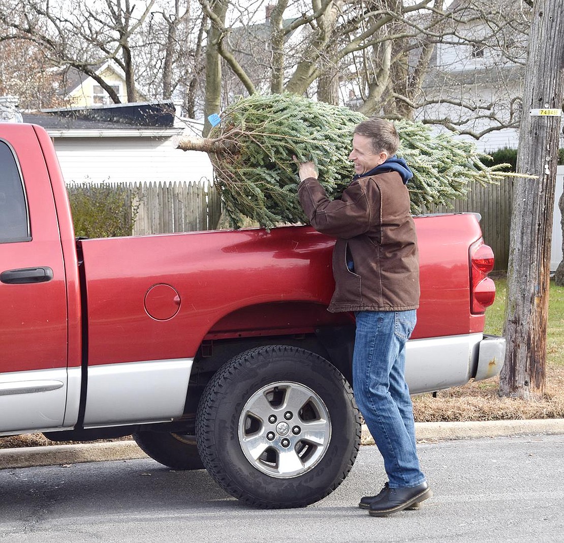 Endearingly referred to as the “delivery boy,” marching band parent and Port Chester Trustee Dan Brakewood loads a tree into his truck to take it to a customer. After the fundraiser, unsold trees are donated to families in need across Port Chester.