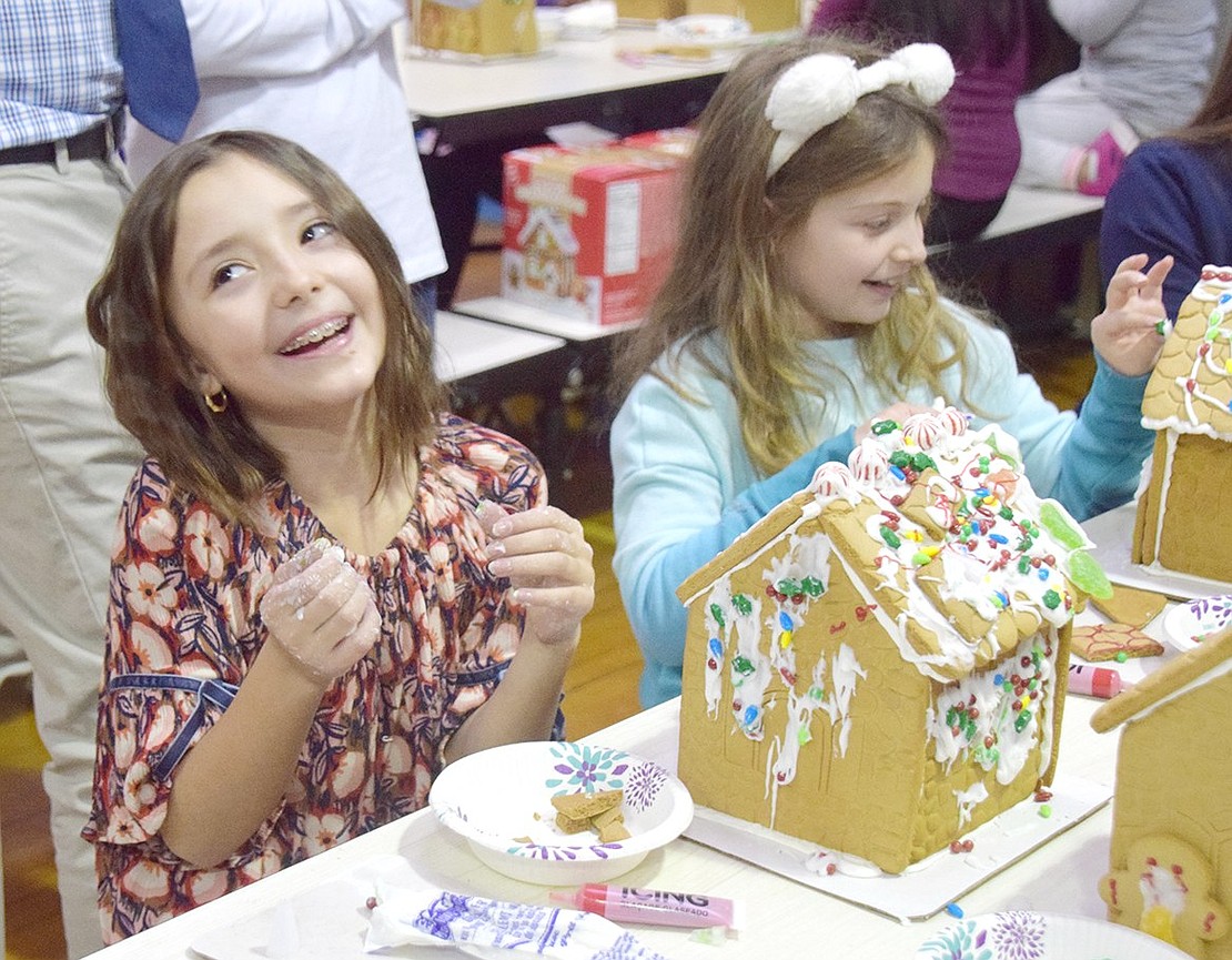 The afternoon is filled with plenty of laughter, sugar and messy hands while friends, such as fourth-graders Deanna Berlingo (left) and Brooke Szygiel, make tasty houses together.