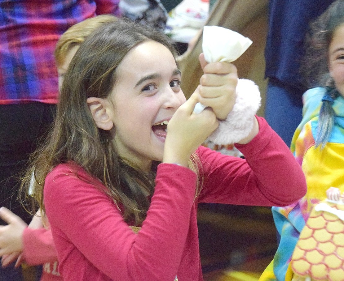 Fifth-grader Isabella Ortiz can’t contain the giggles as she’s caught on camera squeezing frosting into her mouth—not on the house!