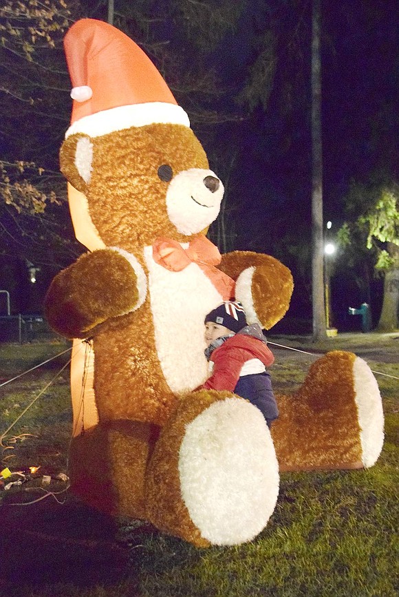 After some coaxing from his mother, Luigi Castellano, 2, approaches a mechanical hugging teddy bear and gives it a long embrace. The Hunter Drive resident is investigating all the winter festivities during the annual Rye Brook Winterfest at Pine Ridge Park on Friday, Dec. 6. 