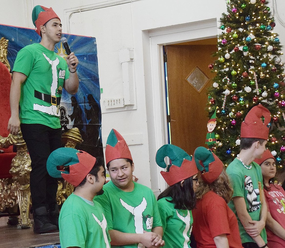 Director of the Don Bosco afterschool programs Andres Alvarez gathers all the elves together before Santa’s big arrival.