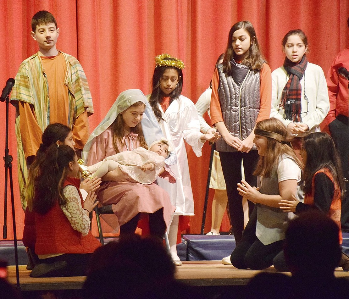 Singing “Come and See” while surrounding Mary (played by Isabella Bezerra) and Baby Jesus (played by Isabella Valdovinos), “The Night Shift Before Christmas” cast recreates the classic nativity scene at the end of the show on Wednesday, Dec. 18. Corpus Christi-Holy Rosary School students celebrate Christmas with a creative musical about the night Jesus was born, set in a fictional diner in Bethlehem called Falafel House.