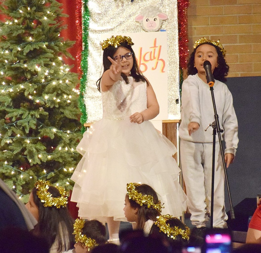 During the angel’s song “Great News of Great Joy,” soloists Analee Aviles (left) and Matthew Valdovinos share the microphone to lead the chorus.