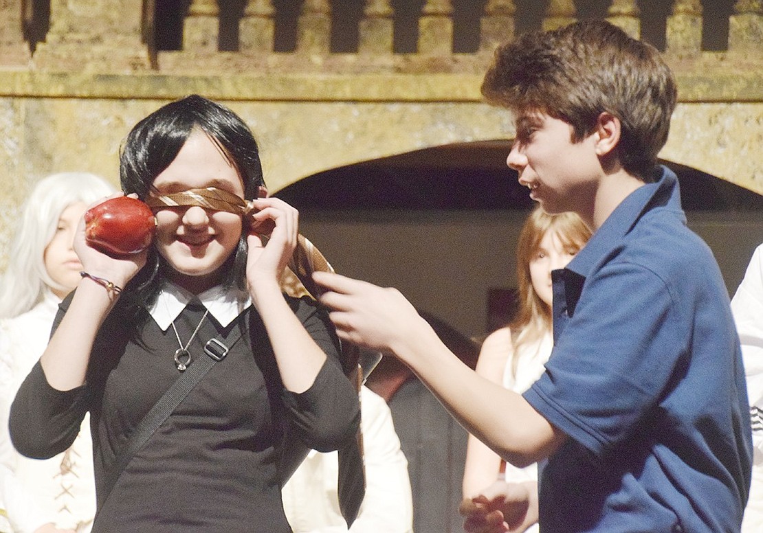 To prove he is just as crazy as Wednesday (played by seventh-grader Abby Meron), Lucas Beineke (played by eighth-grader Will Jaffee) covers her eyes after suggesting she try to shoot an apple off his head while blindfolded. 