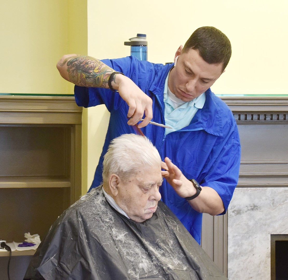 Westchester Barber Academy student Mark Rasulo cuts Breckenridge Avenue resident Domenico Lagana’s hair.