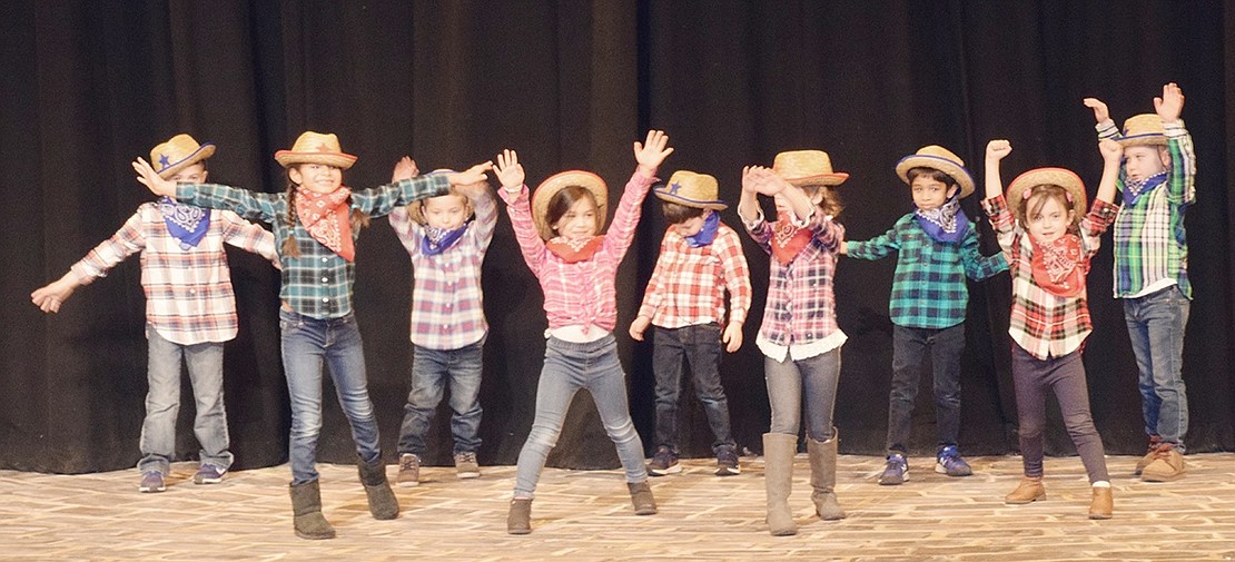 The Bluebirds Buckaroos raise their arms as they get ready to dance and sing along to Lil Nas X’s hit song “Old Town Road” at the talent show, which raised over $7,000 for the Blind Brook Destination Imagination Booster Club.