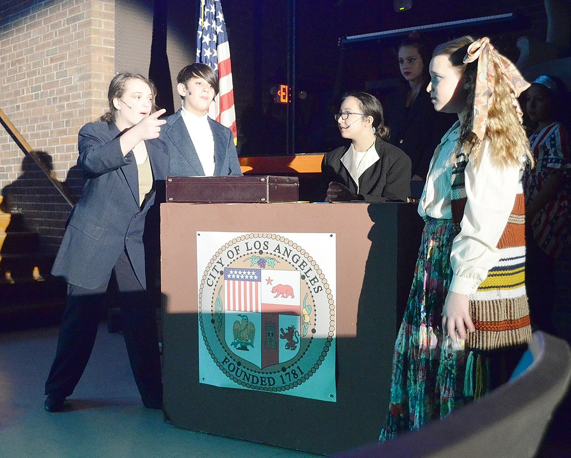 Hilda Klinemann (played by Lucia Giordano) makes her intentions to “rid this city of rock and roll” clear while standing next to her obedient son Franz (played by Sebastian Gimenez). To the right, Regina (played by Katherine Calloway) protests while the mayor (played by Liliana Rufo) listens to the debate.