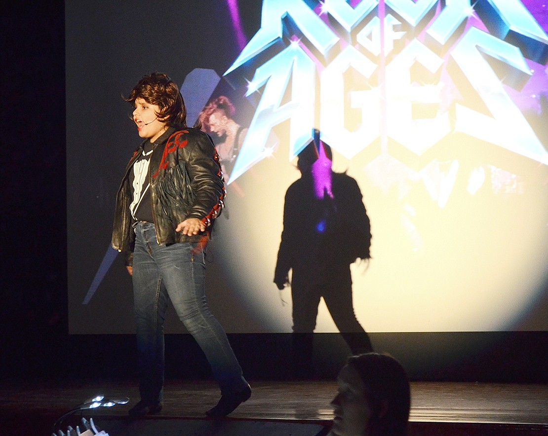 As the narrator of the show, Lonny Barnett (played by Jordan Rivera) sets the scene before introducing the hard-rock characters.