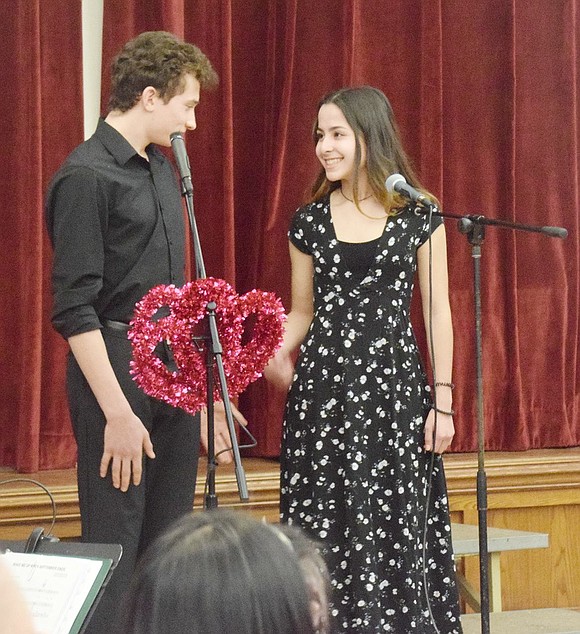 After finishing their duet “Grow As We Go,” seniors Nicolas Arnel and Faith Tomasula take a moment to giggle together as the crowd cheers.