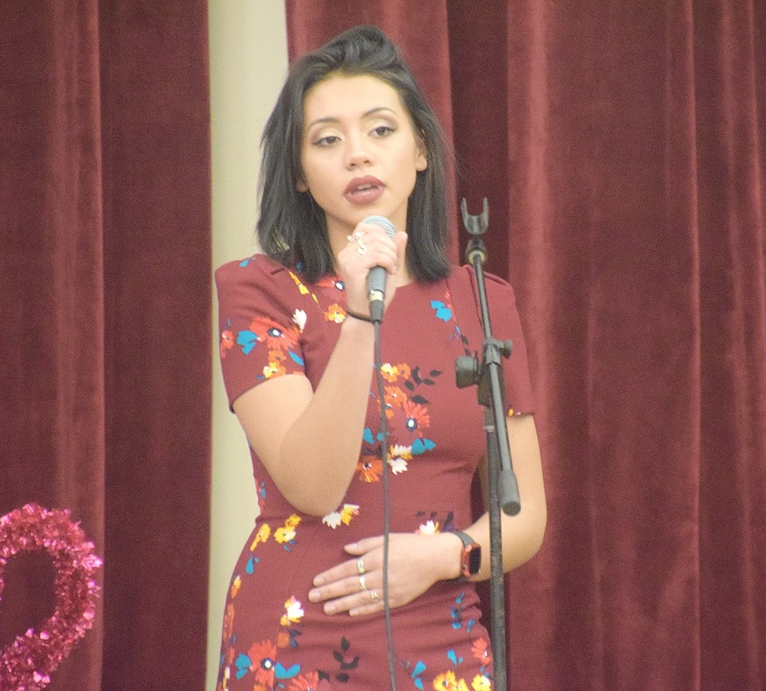 Adorned in a deep red dress appropriate for the holiday, senior Isabel Garcia sings a soulful rendition of “You Say.”