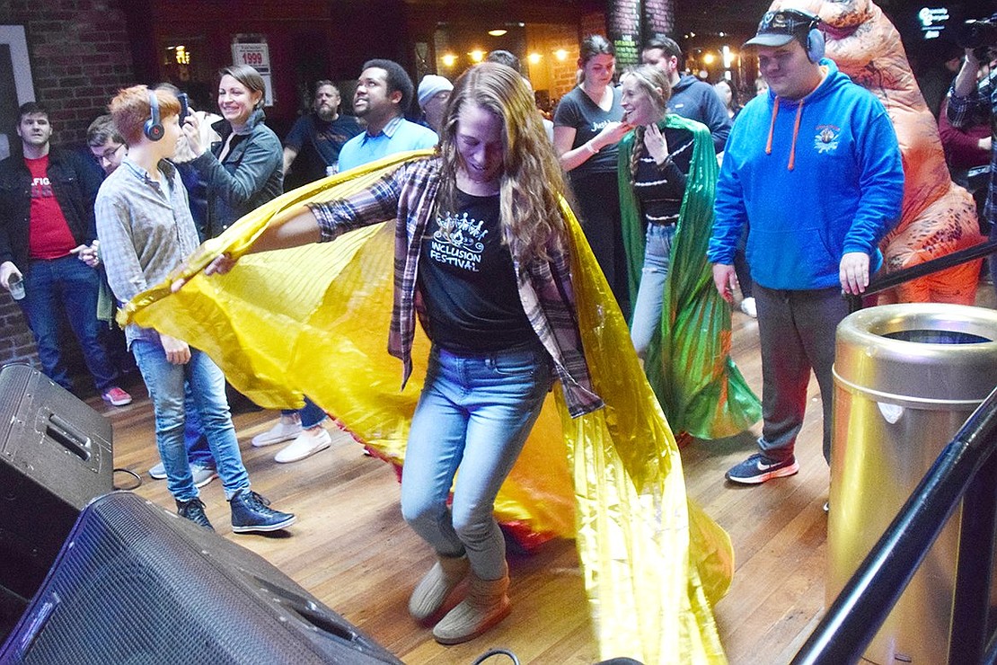 Inclusion Festival Co-founder Leah Barron twirls a bright yellow cape in front of the stage at Garcia’s at the Capitol Theatre during the Especially Everyone Ensemble concert on Sunday, Feb 9. Both organizations strive to create inclusive and accessible experiences for everyone, including those with special needs.