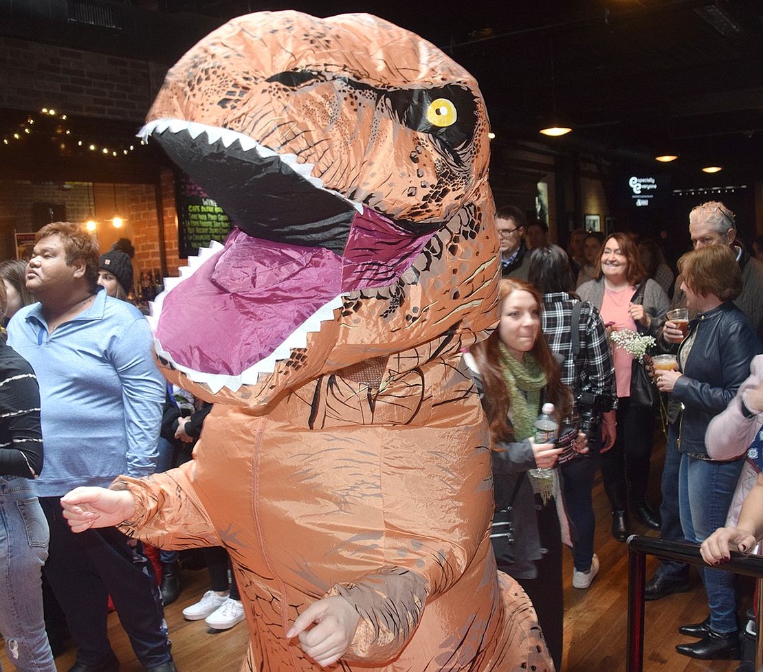 A Tyrannosaurus rex makes a special appearance at the Especially Everyone Ensemble concert to dance with fellow concertgoers. 